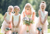 Bride with flower girls around her