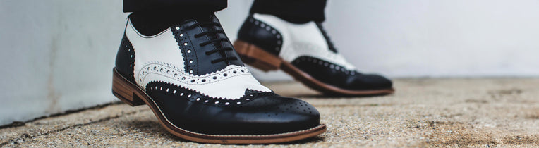 Navy and white two tone wedding brogues worn with a suit