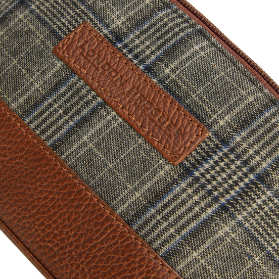 Grey tweed and tan leather washbag, tweed and leather logo close-up